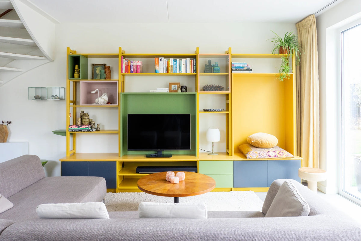 Colourful custom TV wall unit from Lundia with a yellow frame and coloured compartments