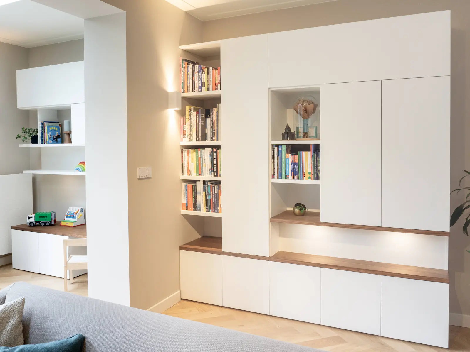 White custom cabinet from Lundia with oak accents and a children's play corner