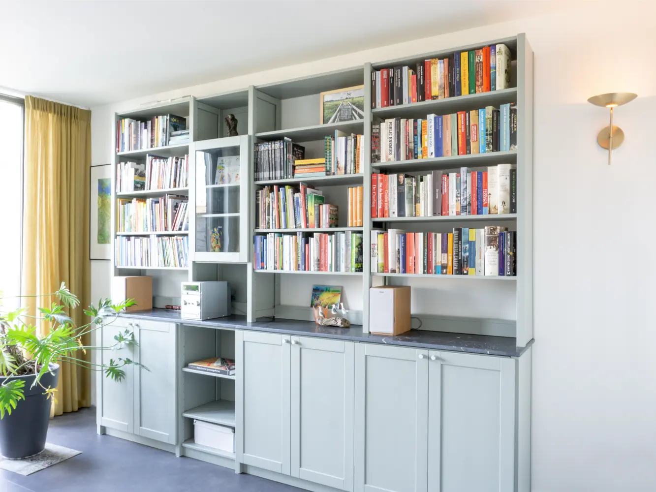 Grey-green custom bookcase from Lundia with a marble worktop